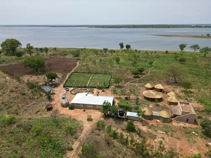 Aerial view of Dream Village in Dambai, Ghana — eco-lodging and farmland on the Oti River, 2025
